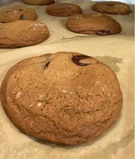 Brown butter chocolate chip cookies cooling on parchment.