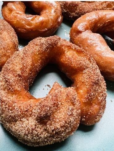Cinnamon sugar cake doughnuts on a tray.