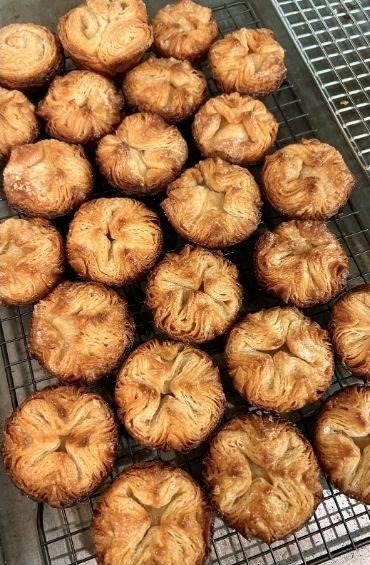 Kouign-amann pastries on a wire rack.